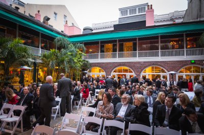 Guests grab their seats in the courtyard before the ceremony